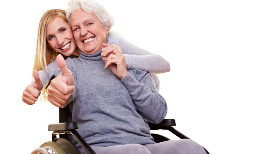 elderly woman and her caregiver showing their thumbs up