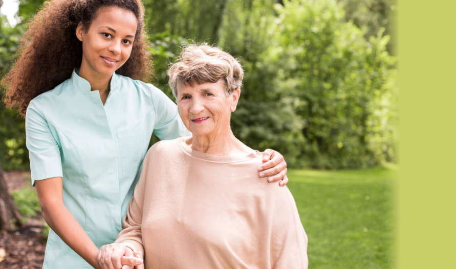 portrait of an old woman her caregiver looking through the camera